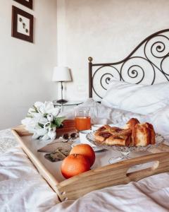 a tray with bread and fruit on a bed at Antica Torre del Borgo in Certaldo +55 photos
