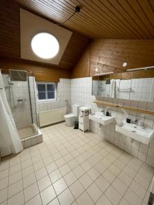 a large bathroom with two sinks and a shower at Urlaub-WeinhofHerrenberg 2 in Schoden