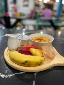 a wooden plate with a banana and a bowl of cereal at GreenDay Escapes Rishikesh in Rishīkesh