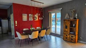 a dining room with a table and yellow chairs at Fietes Achternutkiek in Mellenthin