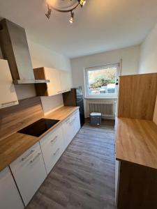 a kitchen with white cabinets and a sink and a window at Reiheneckhaus mit Garten und Terasse in Tettnang