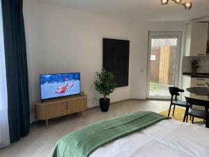 a bedroom with a bed and a flat screen tv at Fewo-Altstadt-Zentrum in Kempten