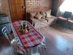 a table with a red and white checkered table cloth at Gardenias Suites Ambuquí Valle de la Eterna Juventud in Hacienda Opote +9 photos