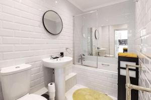 a white bathroom with a sink and a toilet at Modern One Bedroom Duplex Apartment - Central Oxford in Oxford
