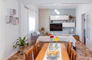 a kitchen and living room with a dining table with at Mare Nostrum in Koutsounari