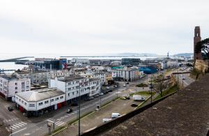 a city with buildings and a street with cars at T1 centre-ville refait à neuf in Brest +5 photos