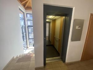 a hallway of an office with an open door at My Sweet Home In The Dolomites - Casa LaLu in Cavalese