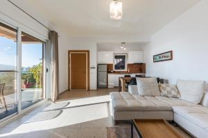 a living room with a couch and a kitchen at Exclusive Seafront Apartments Apartment 3 in Vlorë