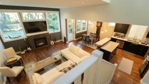 a living room with a couch and a fireplace at Charming scape by Bear Mountain in Victoria