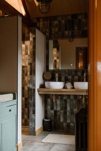 a bathroom with two sinks and a mirror at CRASH'NSTAY - Wachtpost 20 in Waspik +28 photos