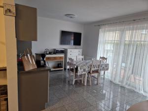 a kitchen and dining room with a table and chairs at Ferienwohnungen Saida Wohnung 3 in Norden