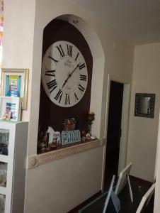 a large clock on a wall in a room at Nicolhouse in Triggiano