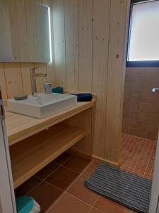 a bathroom with a sink and a mirror at Cabane Alizée, Vensac Océan, Montalivet in Vensac +32 photos