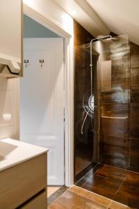 a shower with a glass door in a bathroom at CRASH'NSTAY - Wachtpost 22 in Nieuwe Vaart