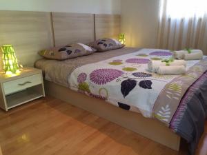 a bedroom with a bed and a table with a night stand at Apartments Hrboka in Žman