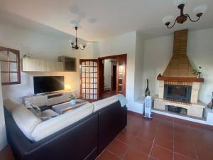 a living room with a couch and a fireplace at El Álamo, tranquilidad y naturaleza in Teror