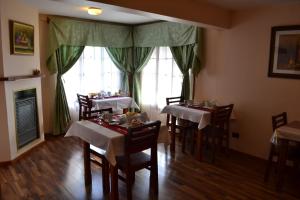 a dining room with tables and chairs and a fireplace at Valle Frío Ushuaia in Ushuaia