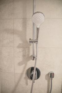 a shower with a shower head and a drain at Newly renovated apartment in Wenceslas square in Prague