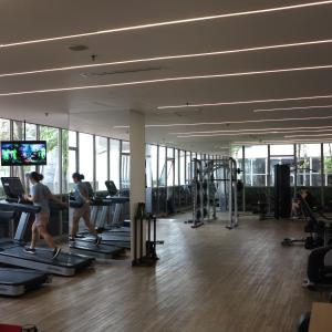 two women running on treadmills in a gym at Apartment Goldcoast-Studio Room in Jakarta