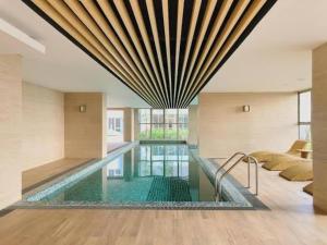 a swimming pool in the middle of a building at Apartment Goldcoast-Studio Room in Jakarta