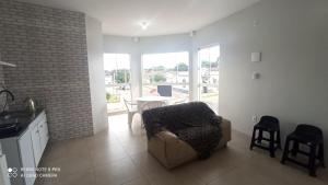 a living room with a couch and a table with chairs at Apartamento com Vista Panorâmica in São Gabriel