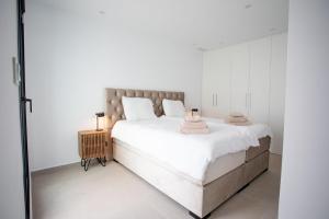 a white bedroom with a large bed with white walls at Buena Vida Dolores in Dolores +35 photos