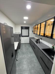 a kitchen with a refrigerator and a table in it at Modern Apartments, Wohnung Nr 2, nahe Schalke Arena, Zentral zur Autobahn A42 und A2, Ferienwohnung, Monteurwohnung in Gelsenkirchen