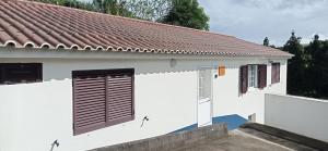 a white house with a brown roof at Villa Visconde in Nordeste