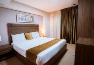 a bedroom with a large bed in a hotel room at Rawa Luxury Hotel Suites in Amman