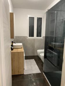 a bathroom with a shower and a sink and a toilet at Colibrì Art B&B in San Martino in Argine