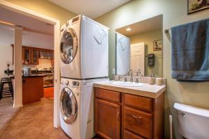 a bathroom with a washer and dryer next to a sink at Northern Daylights in White Salmon +12 photos