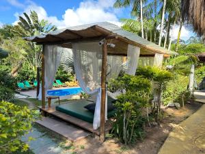 a gazebo with a canopy and a bed at Bosque do Arraial in Arraial d'Ajuda