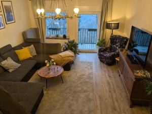 a living room with a couch and a table at Ferienwohnung am Steinweg in Solingen