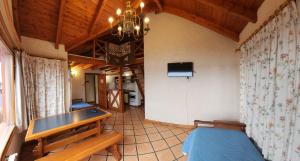 a room with a ping pong table in a house at Brisas del Lago in San Carlos de Bariloche