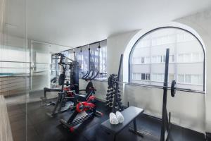 a gym with treadmills and ellipticals in a building at Miramar Hotel in Balneário Camboriú