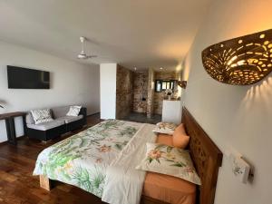 a bedroom with a large bed and a couch at Villa ALDIANA in Cap Skirring +35 photos