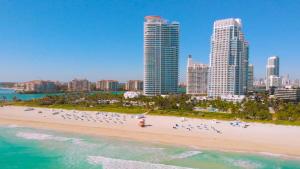 a beach in front of a city with tall buildings at 2-Min to Beach, Upscale Enclave in Miami Beach