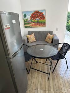 a living room with a couch and a table and a refrigerator at Damaris Bed & Breakfast in Las Terrenas