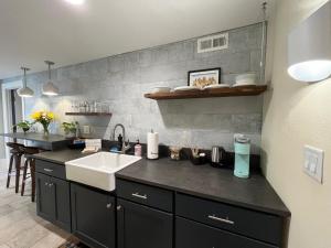 a kitchen with a sink and a counter top at Dougan Suites in Portland