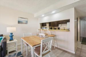 a dining room and kitchen with a table and chairs at Charming Beach Condo in St Augustine in Saint Augustine +35 photos