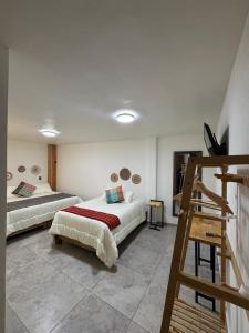 a bedroom with two beds and a ladder in it at Estancias HGS in Santiaguito +8 photos