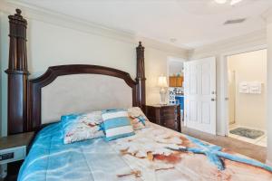 a bedroom with a bed with a wooden head board at Two Bedroom St Augustine Retreat in Saint Augustine