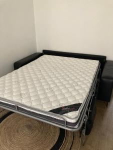 a mattress on a bed frame in a room at Studio centre proche marché et RER avec wifi in Saint-Germain-en-Laye