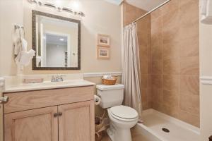 a bathroom with a toilet and a sink and a shower at Oceanview Retreat in St Augustine in Saint Augustine +26 photos