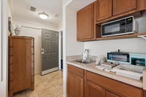 a kitchen with a sink and a microwave at Tranquil Coastal Retreat in St Augustine in Saint Augustine