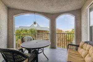 a patio with a table and chairs on a balcony at Tranquil Coastal Retreat in St Augustine in Saint Augustine +7 photos