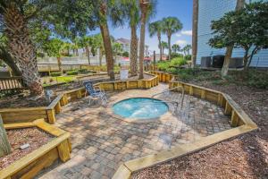 a small pool in a patio with a table and a chair at Tranquil Coastal Retreat in St Augustine in Saint Augustine