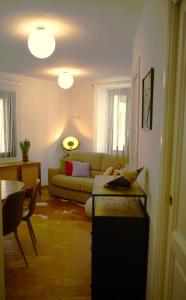 a living room with a couch and a table at Suite "La Finestra su Alghero" in Alghero