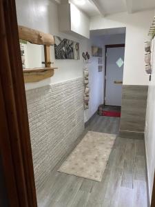 a room with a tile floor and a hallway at Coaltown Cottage Cosy 4 bed cottage with log burner, close to Gower beaches in Dunvant