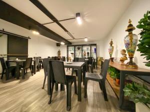 a restaurant with tables and chairs in a room at Orbe Hotel Medellín in Medellín